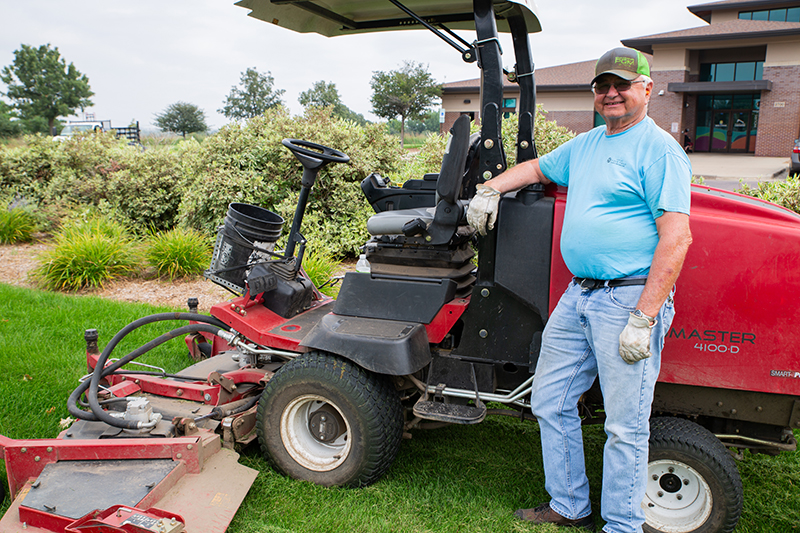 Parks employee mowing