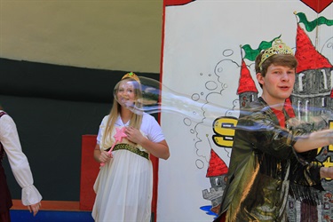 actors in costume performing on stage