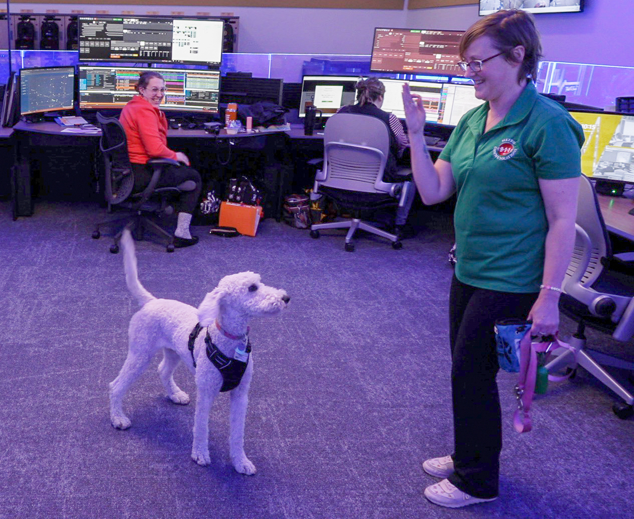 Nena and a handler practice commands in the Metro 911 command center