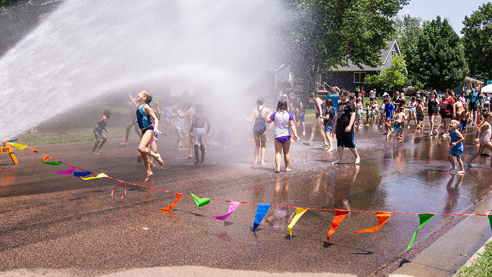 Children jumping and having fun at the hydrant block party