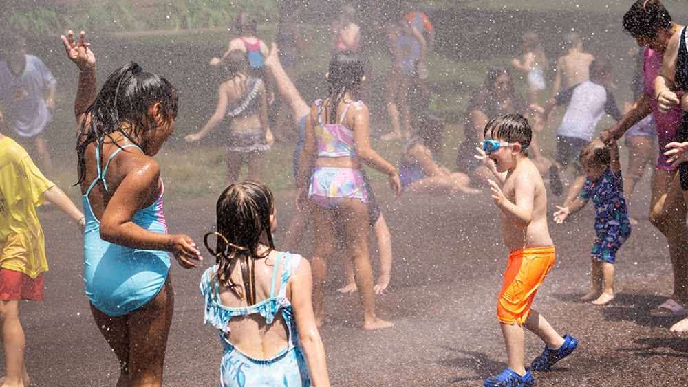 Children jumping and playing in the water