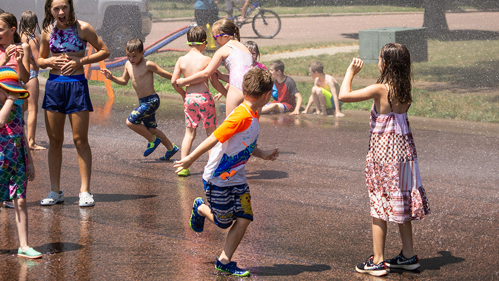 Children running around and having fun at the hydrant block party