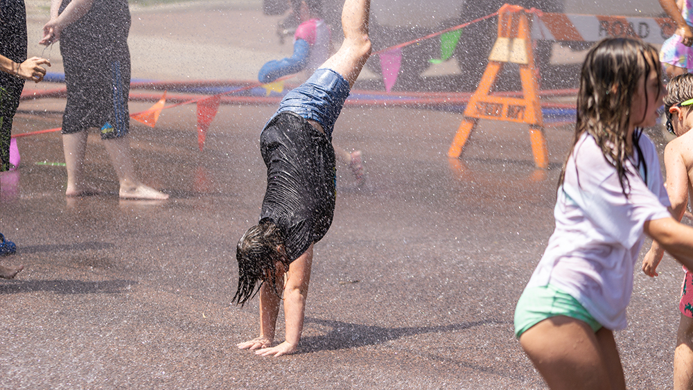 Child cartwheeling at the hydrant block party