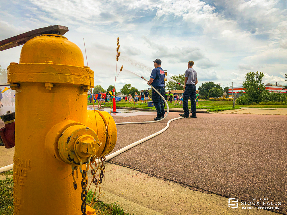 Fire Rescue spraying the crowd for hydrant block party